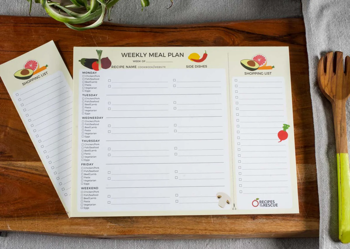 Open notebook with a hand-drawn weekly meal plan and shopping list